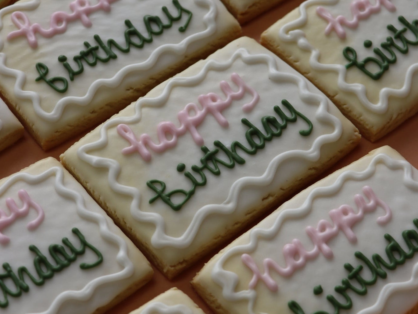 Decorative custom cookies with 'Happy Birthday' text on a white background
